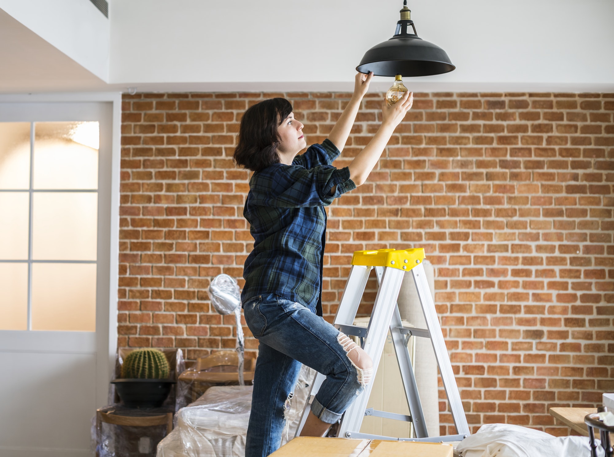 Woman changing lightbulb